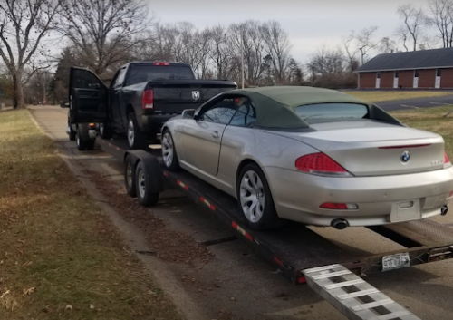 Luxury sedan being transported on trailer